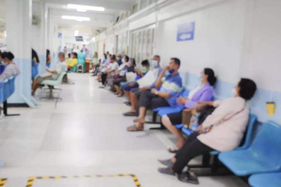 Blur image of patients in a hospital waiting area.